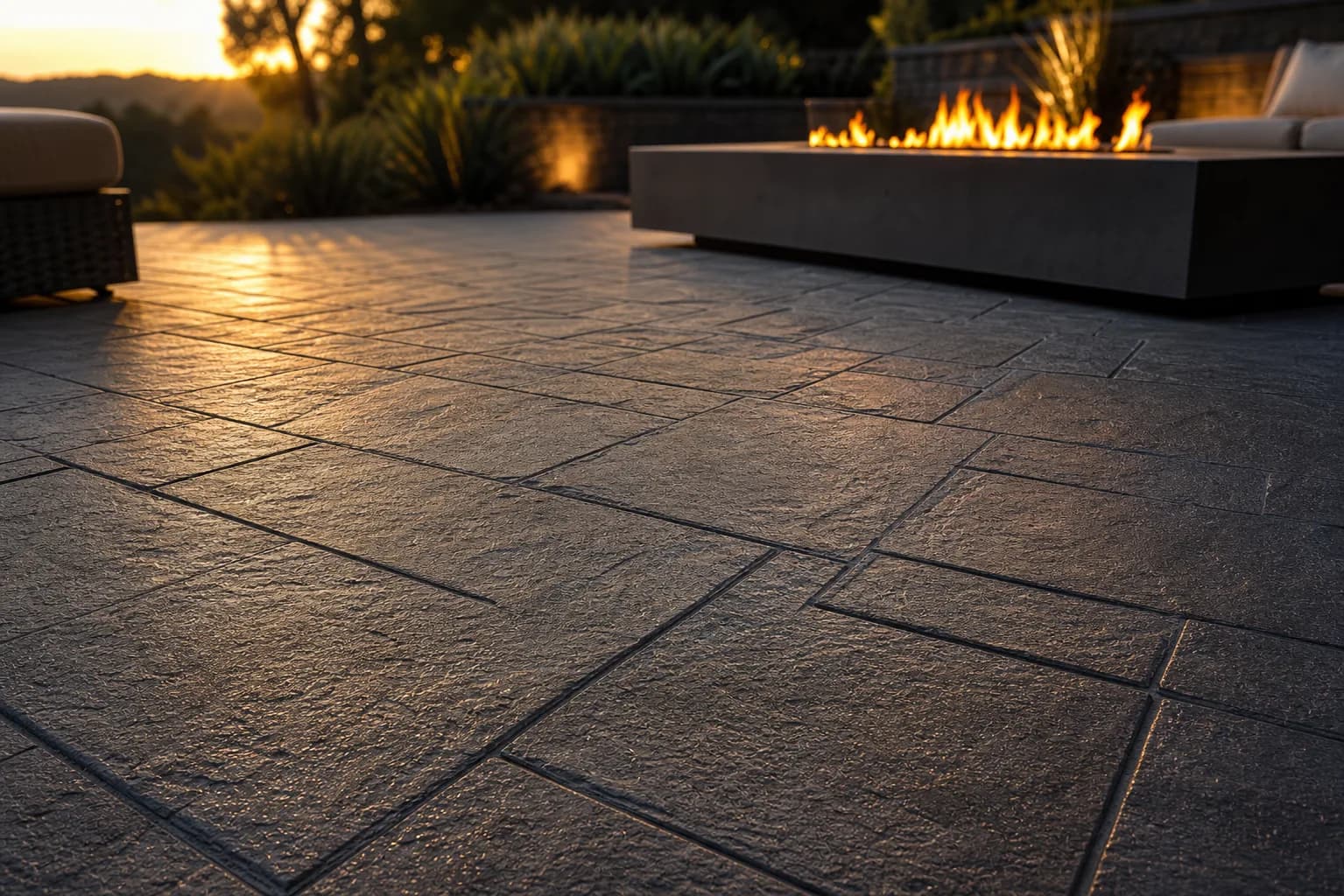 Stamped concrete patio texture with fire feature in warm evening light