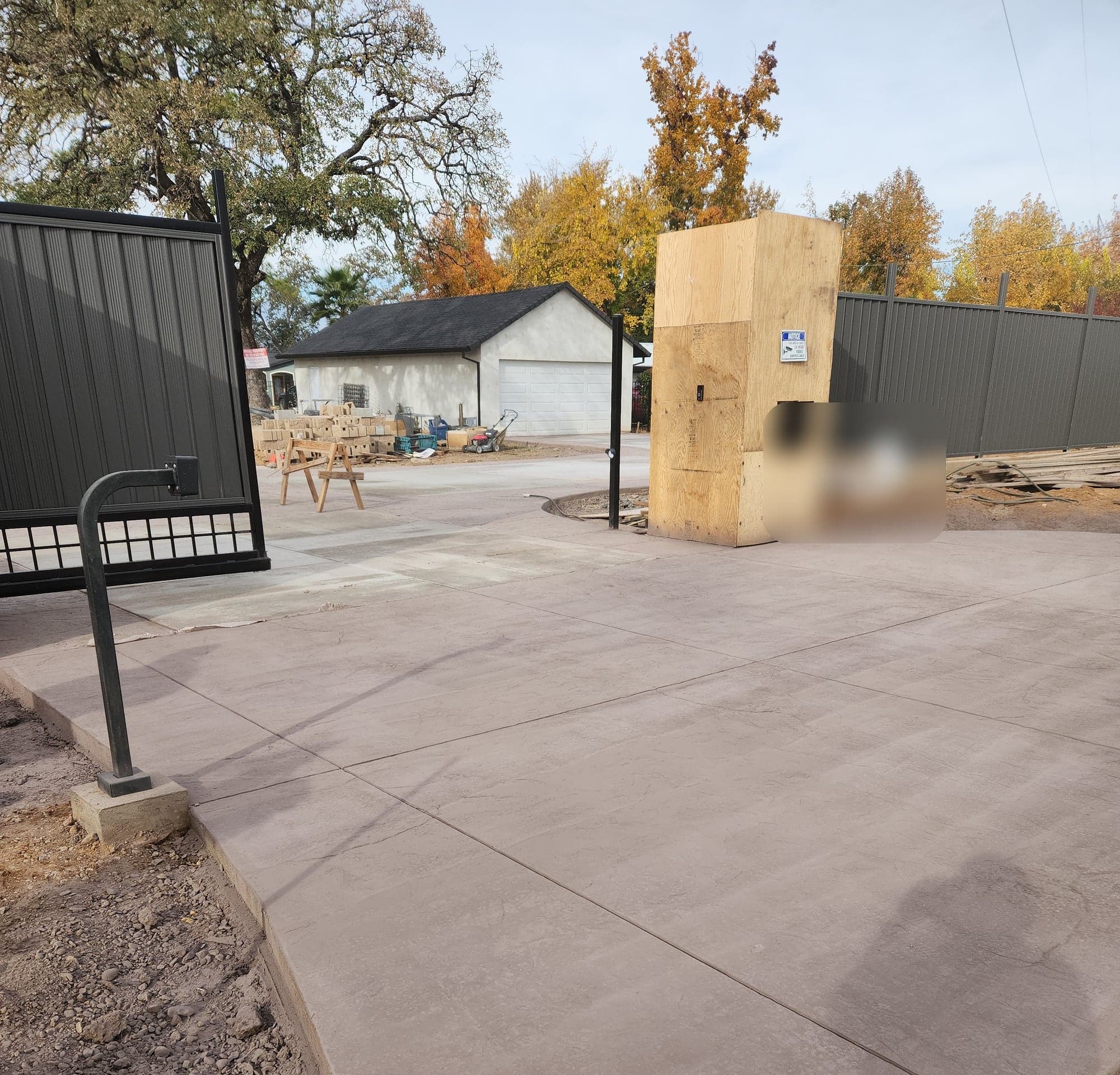 The finished apron where the driveway meets the gate, showing the panel joints and textured surface