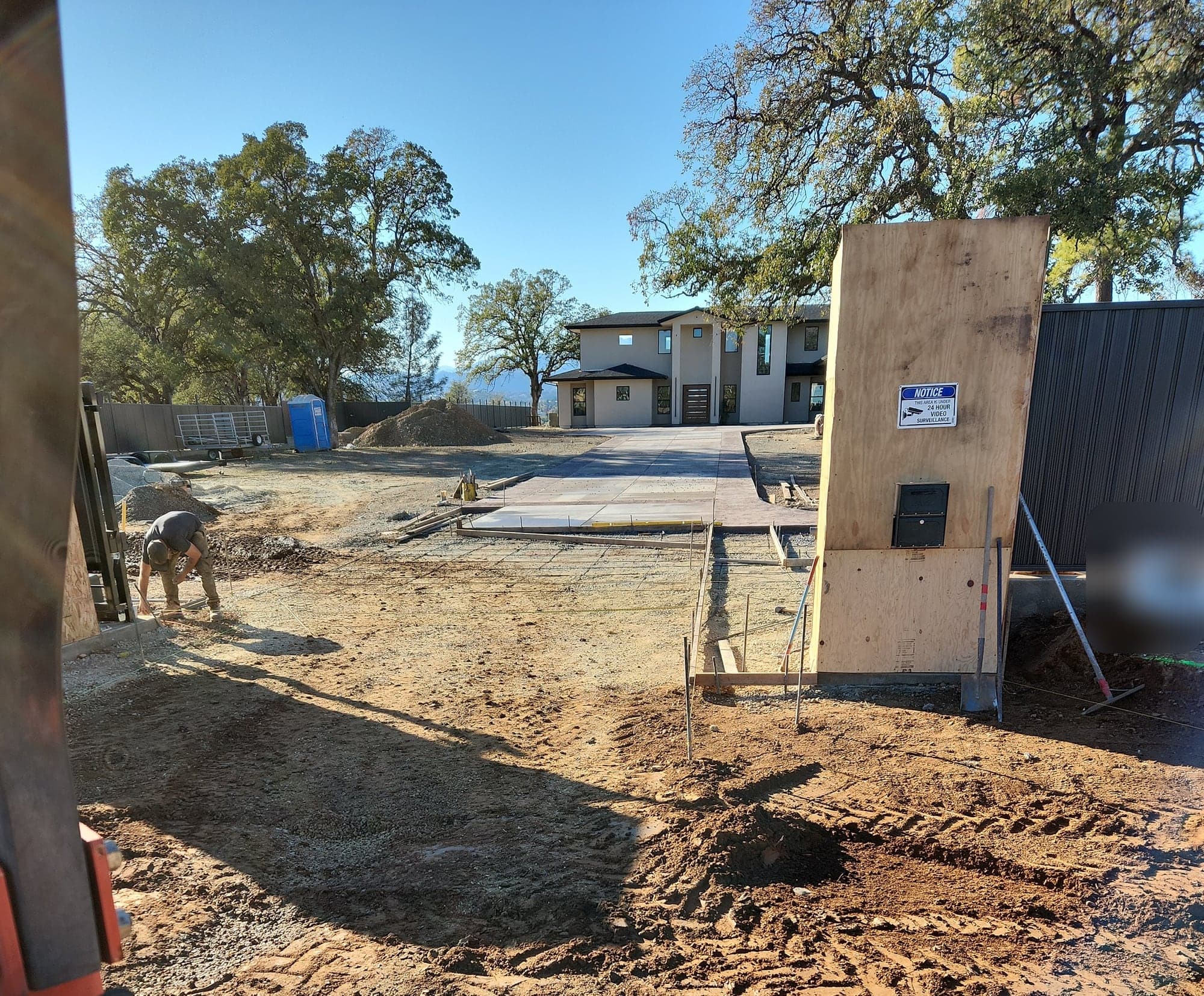 The approach cut and graded before forming, with the new house in the background