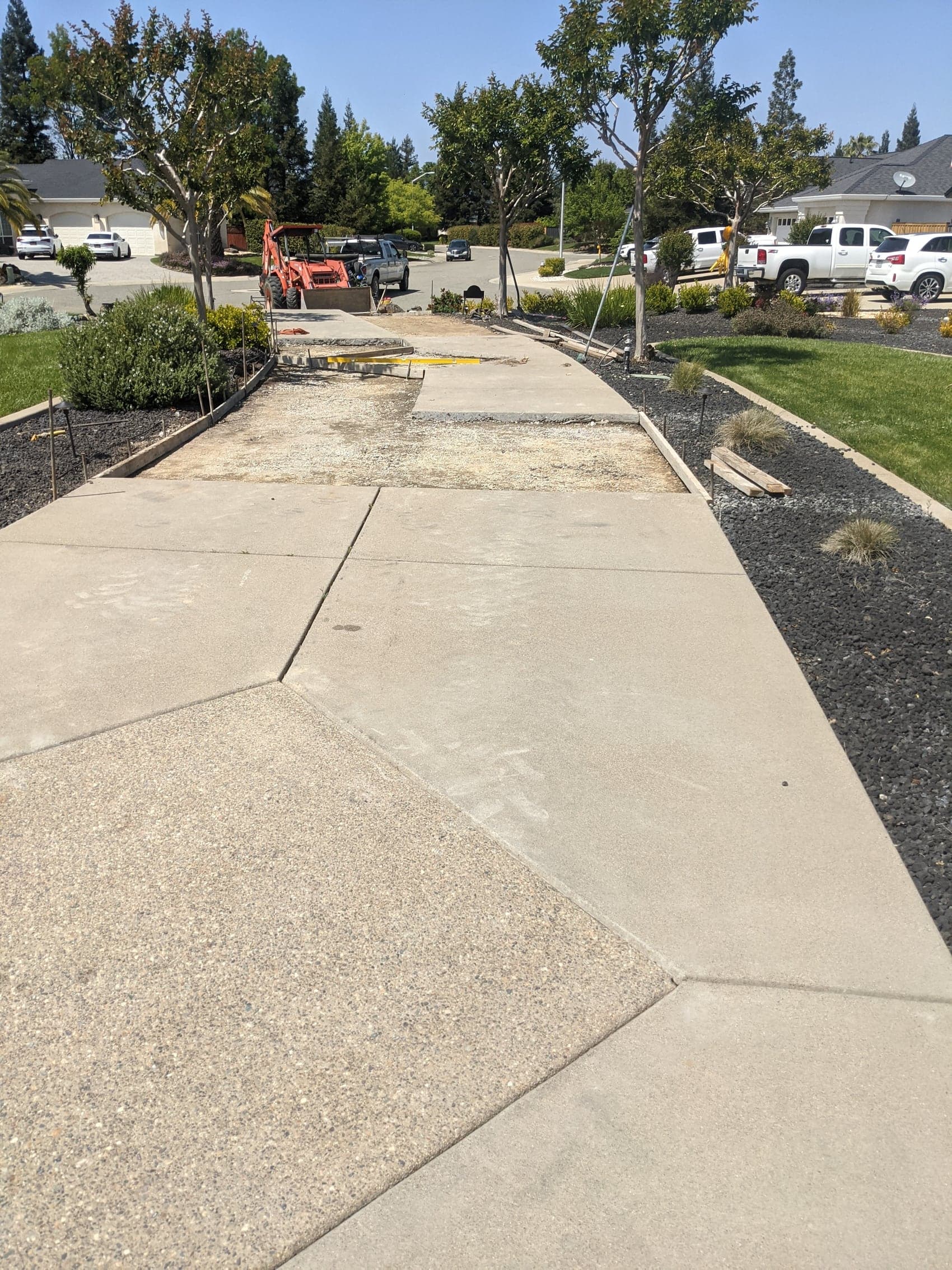 A walkway part way through replacement, with the old section removed and a fresh compacted base in place